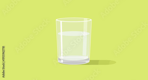A glass of water sits on a vibrant green surface indoors.