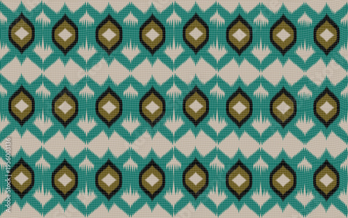 A repeating pattern of teal and gold diamond shapes on a woven rug