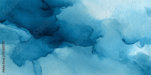 Abstract watercolor washes of deep blues, creating a serene and ethereal atmosphere. The image captures the fluidity and beauty of the watercolor technique.
