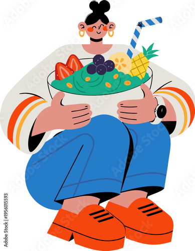 Woman holding a green smoothie bowl filled with fruits including strawberries, pineapple, and blueberries, wearing colorful clothing, seated with a playful expression