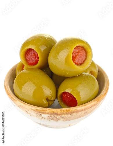Stuffed green olives in a small bowl, isolated on white background