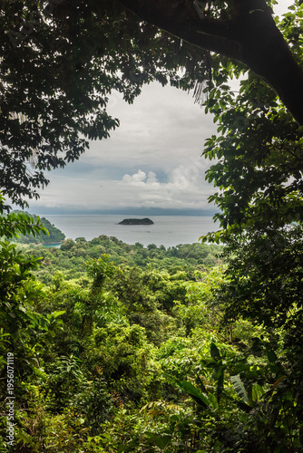 Vertical shot of a viewpoint with a distant beach landscape and vegetation in the background in Manuel Antonio National Park located in the province of Puntarenas in Costa Rica.