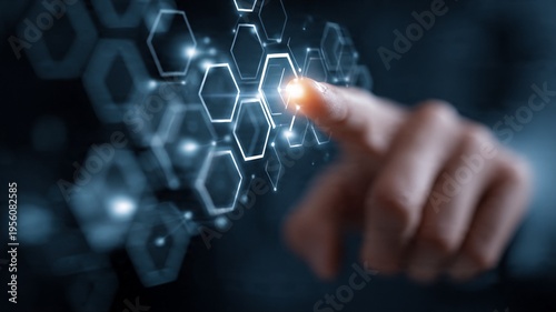 Hand interacting with futuristic digital interface featuring hexagonal patterns