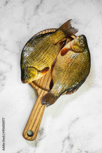 The fish are golden with distinct scales and fins, ready for cooking