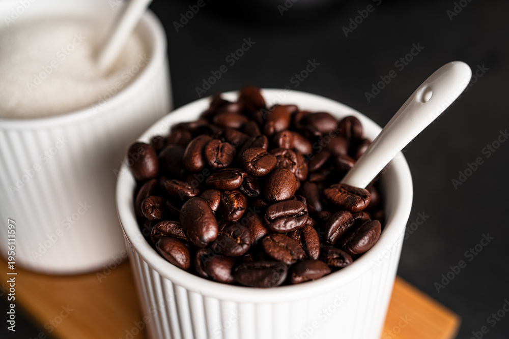 Fototapeta premium Coffee beans on a dark background. Coffee beans in cup. High quality photo