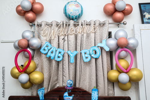 Baby shower decoration setup with balloons and welcome baby boy sign, celebration party background