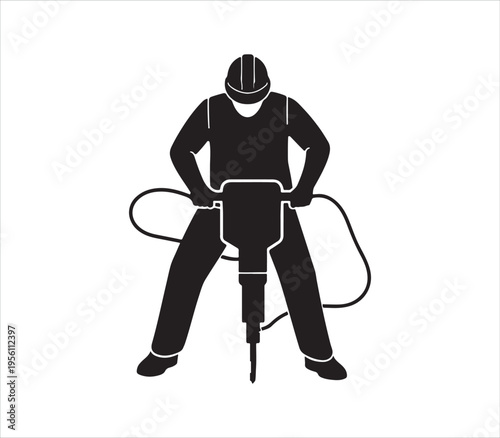 Worker operating heavy duty jackhammer equipment on construction site