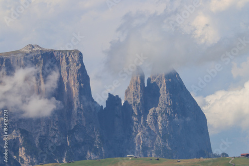 Dramatic Dolomite Cliffs Surrounded by Low Mist