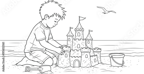 Young boy building a sandcastle on the beach with a bucket