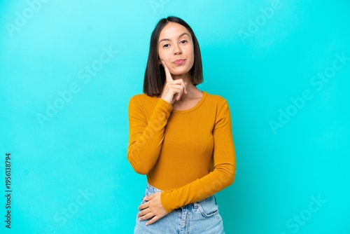 Young caucasian woman isolated on blue background happy and smiling covering mouth with hands