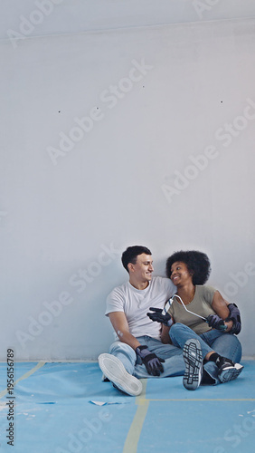 Bild auf Leinwand A young couple engages in playful banter while working on a DIY home improvement project in a renovated space