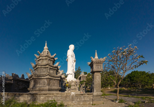 Standing Buddha statue against sky at Tong Lam Son Temple Nha Trang Vietnam