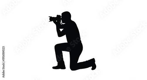 A photographer takes a picture in a kneeling position