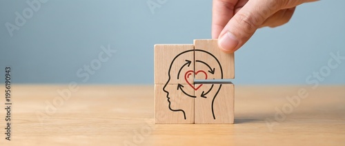 Hand carefully positions the final wooden block to complete a compelling puzzle of a human head profile, featuring a central heart with encircling arrows.