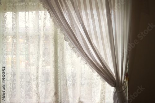 фотографія This fabric is a type of sheer lace fabric for curtains with a floral motif