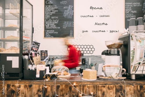 A busy cafe scene with a barista preparing coffee. . The cafe has a warm, inviting atmosphere. Busy barista, blurred in motion