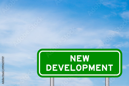 Green color transportation sign with word new development on blue sky with white cloud background