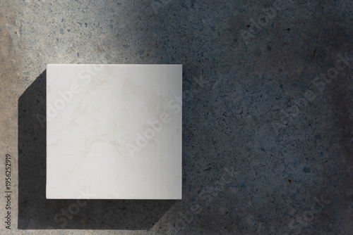 An aesthetic arrangement of interior design material samples featuring light and warm wood grain textures paired with a central white marble or quartz stone swatch.