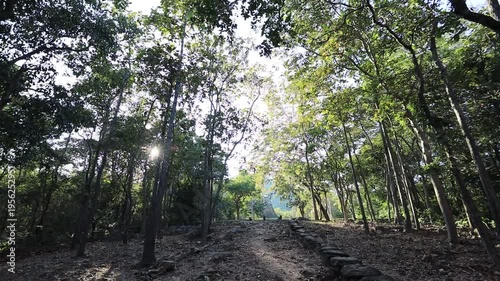 The video's natural background depicts the atmosphere of the ancient Sukhothai Historical Park, an educational site featuring ancient Buddha statues and pagodas.