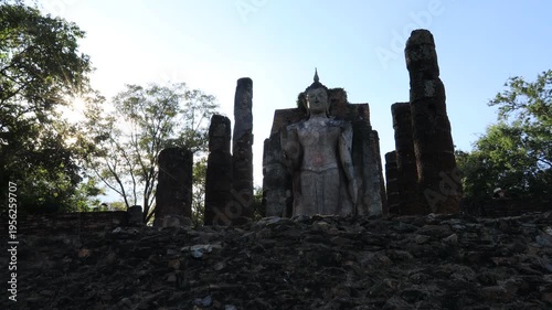 The video's natural background depicts the atmosphere of the ancient Sukhothai Historical Park, an educational site featuring ancient Buddha statues and pagodas.