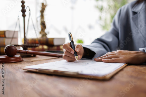 Fotografie Lawyers discussing contract papers sitting in the table at office in the morning