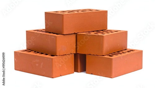 A close-up shot of several reddish-brown, rectangular building blocks, arranged in a small, stable stack. They have holes