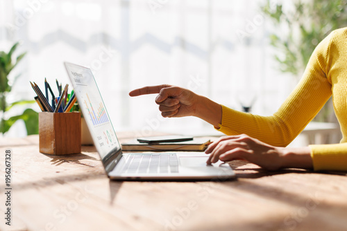 Tableau sur toile Business hand point to graphs and charts to analyze market data, balance sheet, account, net profit to plan new sales strategies to increase production capacity