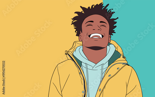 Young man smiles while wearing a yellow jacket and standing in front of a colorful background in a cheerful setting