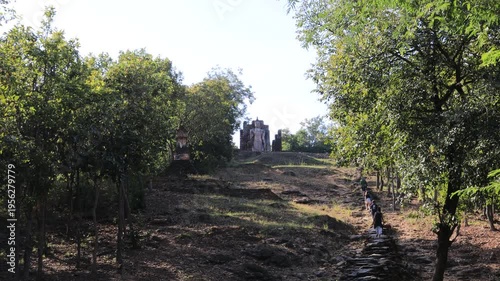 The video's natural background depicts the atmosphere of the ancient Sukhothai Historical Park, an educational site featuring ancient Buddha statues and pagodas.