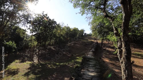 The video's natural background depicts the atmosphere of the ancient Sukhothai Historical Park, an educational site featuring ancient Buddha statues and pagodas.