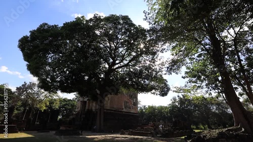 The video's natural background depicts the atmosphere of the ancient Sukhothai Historical Park, an educational site featuring ancient Buddha statues and pagodas.