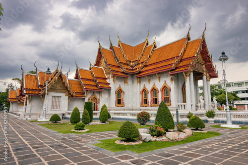 The Marble Temple Wat Benchamabophit under a cloudy sky in Bangkok, Thailand.