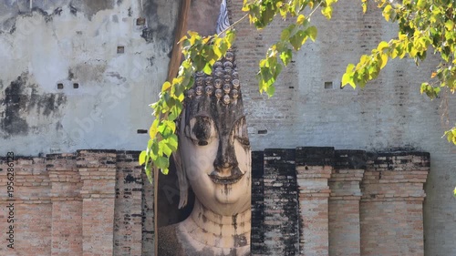 The video's natural background depicts the atmosphere of the ancient Sukhothai Historical Park, an educational site featuring ancient Buddha statues and pagodas.