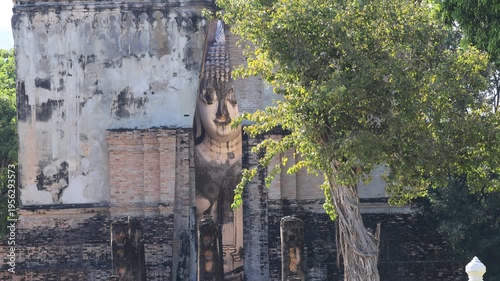 The video's natural background depicts the atmosphere of the ancient Sukhothai Historical Park, an educational site featuring ancient Buddha statues and pagodas.