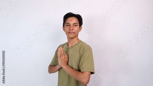 Canvas Print Asian young man smiling greeting gesture