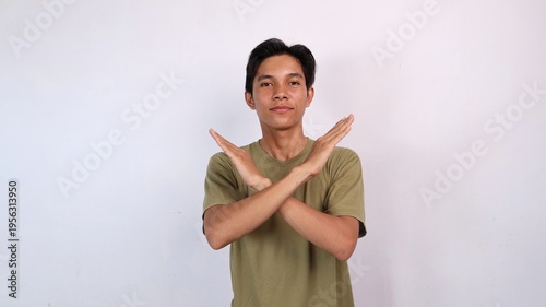 Asian young man gesturing with both hands crossed, rejection