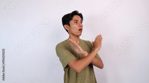Asian young man gesturing with both hands crossed, rejection