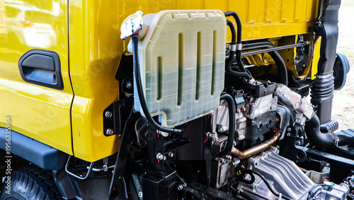 Photos Detailed view of an industrial vehicle's engine compartment, prominently featuri