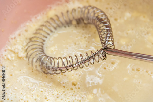 Photos Using a metal whisk, knead the dough in a bowl