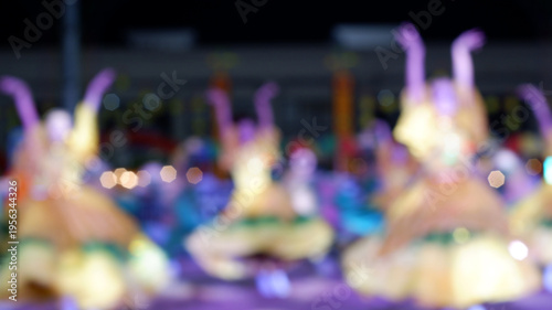 Cultural dancers in traditional costumes from nearby towns perform their practiced dance steps at a government-sponsored trade fair held in the public grounds. Blurs