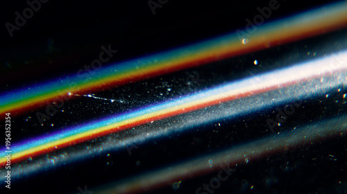 Rainbow prism light streaks on dark background abstract refraction