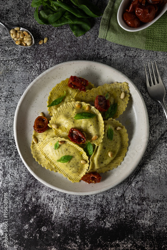 Italian ravioli with pesto and sun dried tomatoes, gourmet restaurant dish and food styling concept
