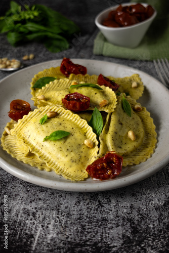 Italian ravioli with pesto and sun dried tomatoes, gourmet restaurant dish and food styling concept