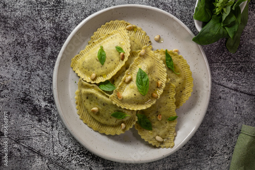 Italian ravioli with pesto sauce and basil on plate, gourmet food lifestyle concept