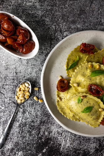 Italian ravioli with pesto, basil and pine nuts, traditional recipe and food marketing concept