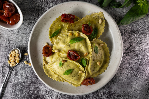 Italian ravioli with pesto, basil and pine nuts, traditional recipe and food marketing concept