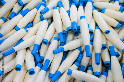 Many spinning spools are stacked together