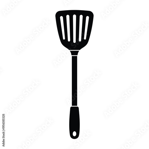 A black slotted kitchen spatula is displayed vertically against white.