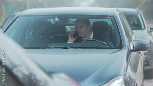 Driver calmly manages traffic stop, Driver interacts peacefully with app during city traffic standstill