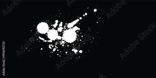 White color spray paint or graffiti design element on the black wall background.